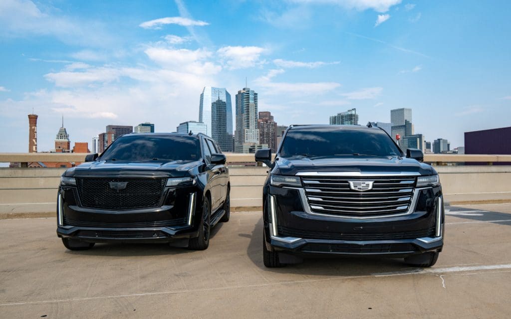 Black SUVs and the downtown Denver skyline, the executive car service Denver visitors arrive in